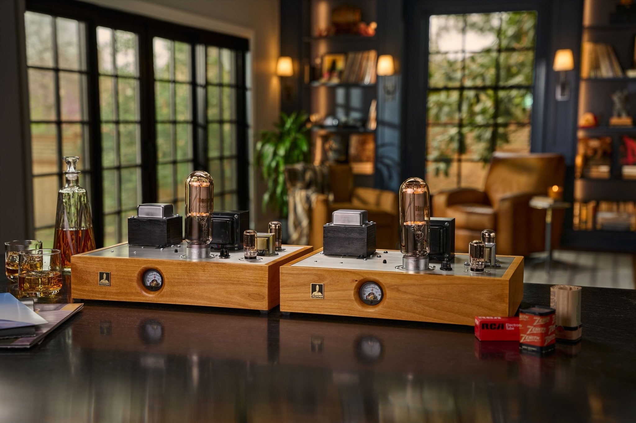 Bottlehead Paradyne monoblocks with vinyl records, some whiskey in glasses, and tube boxes.